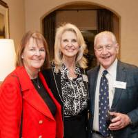 J.C. Huizenga and two other women attending party standing together and smiling at camera